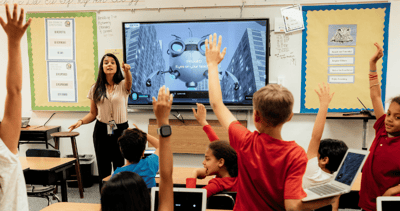 Teacher calling on students with raised hands