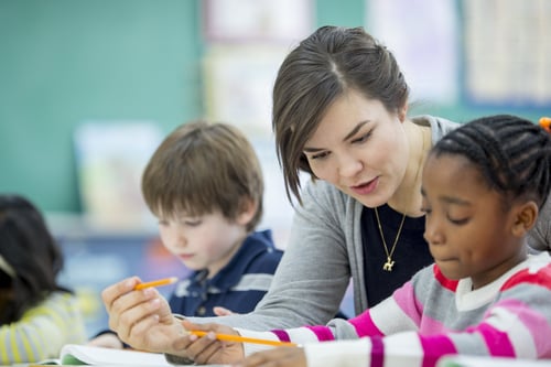 Teacher helping Students